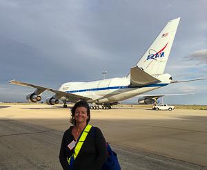 Dr. Smith on the tarmac at the Armstrong Flight Research Center in Palmdale, CA, getting ready to board the SOFIA aircraft to observe massive forming stars.